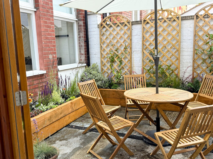 British-grown plants in a pollinator-friendly courtyard garden with timber seating at a Bristol office